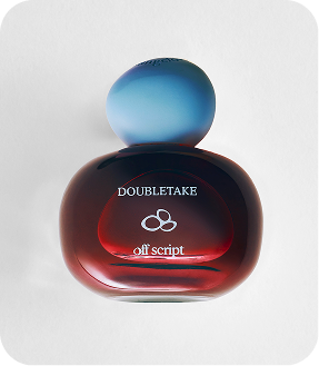 Doubletake Off-Script perfume bottle with a dark red glass body and a blue gradient spherical cap, shown on a light gray background.